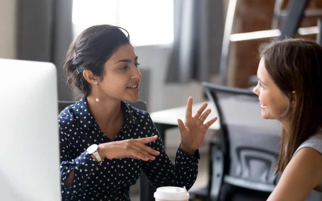 Two people having an animated conversation with hand gestures.